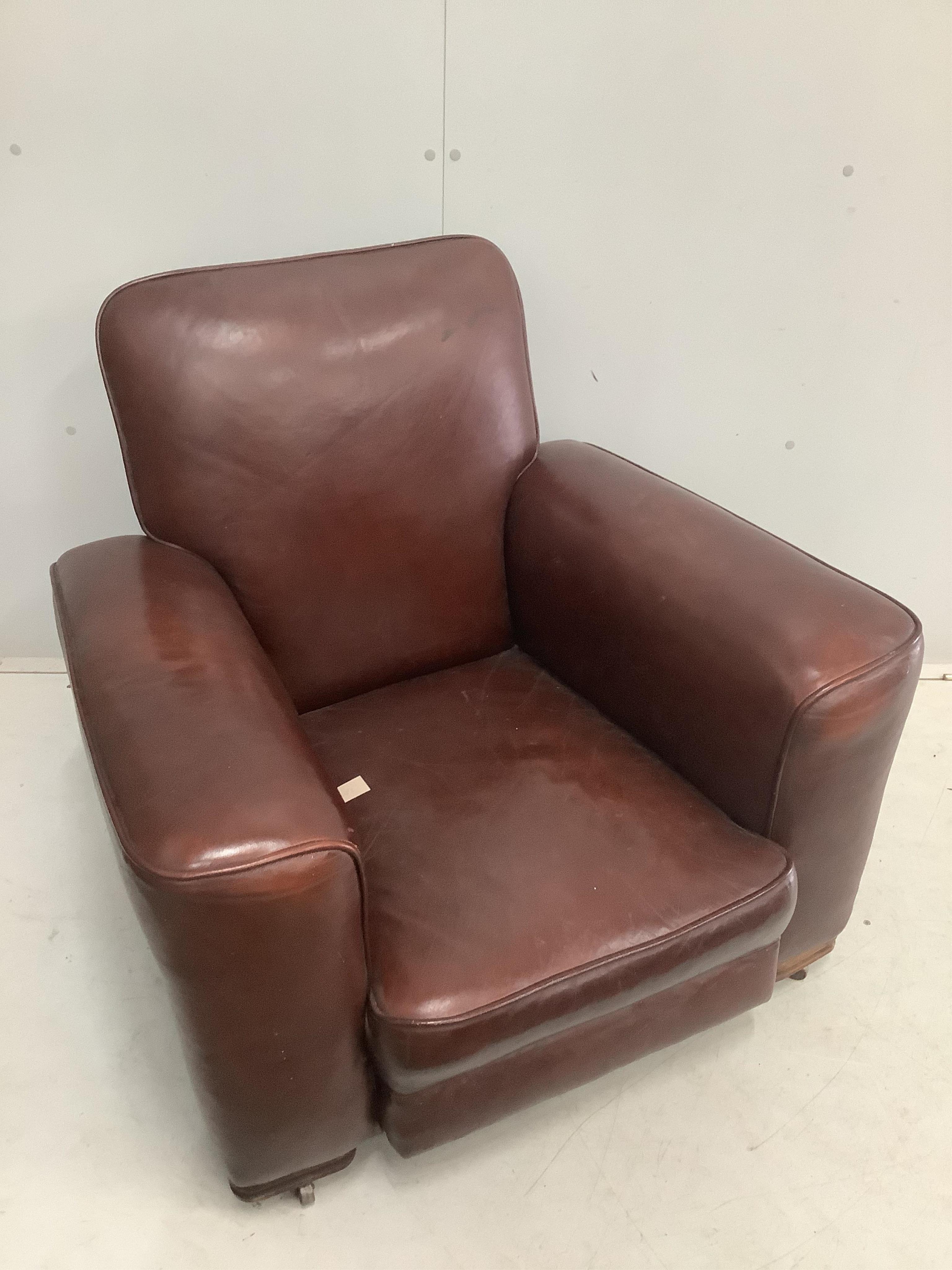 A 1930's brown leather club armchair, width 92cm, depth 75cm, height 80cm